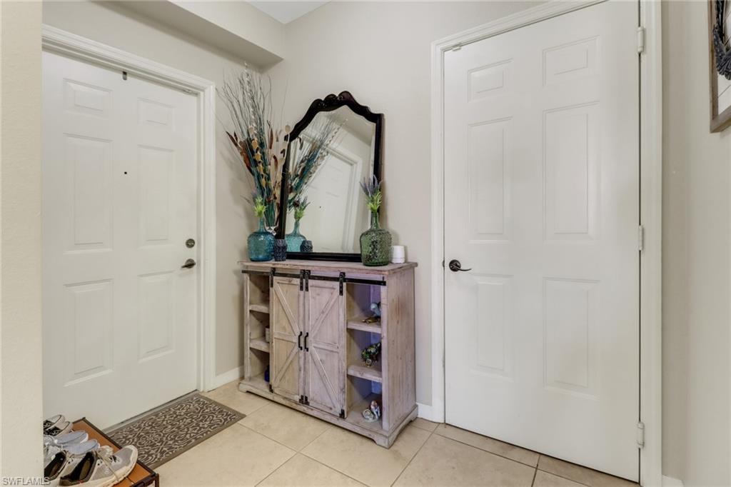 20221 Estero Gardens Circle, Unit 104 Estero, FL 33928 - Photo 2 of 43 a view of a hallway with wooden floor and closet
