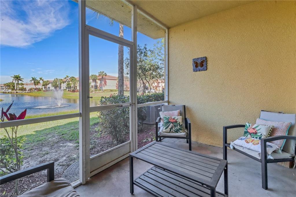 20221 Estero Gardens Circle, Unit 104 Estero, FL 33928 - Photo 23 of 43 a view of a balcony with chair and table