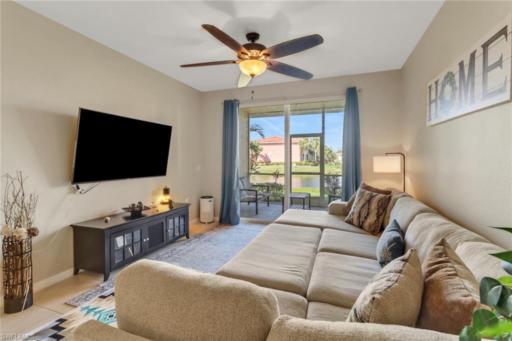 20221 Estero Gardens Circle, Unit 104 Estero, FL 33928 - Photo 9 of 43 a living room with furniture and a flat screen tv