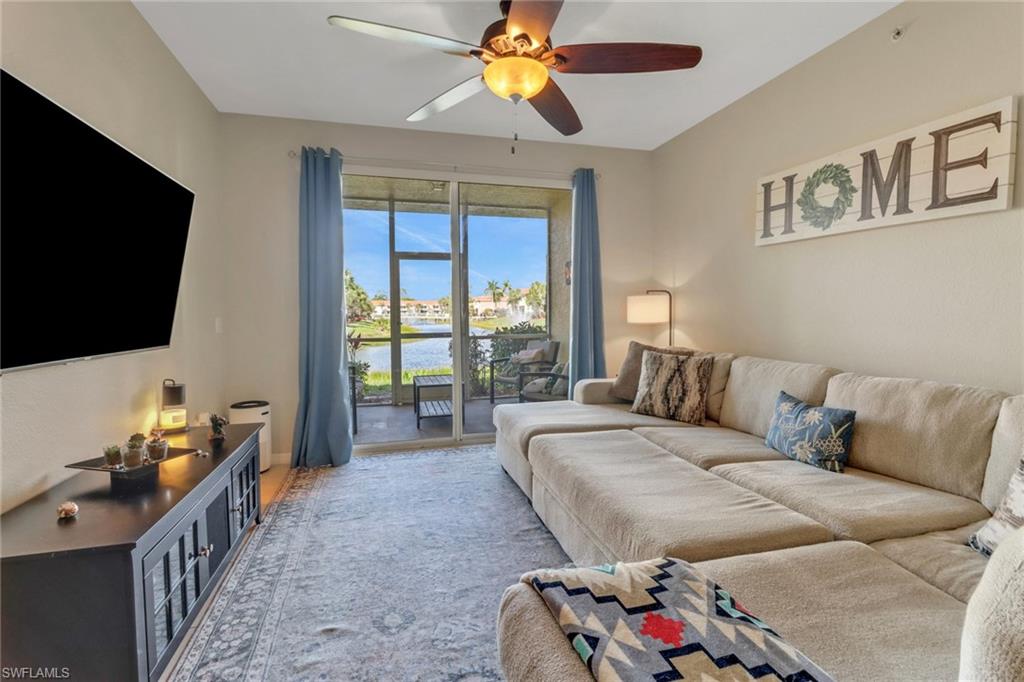 20221 Estero Gardens Circle, Unit 104 Estero, FL 33928 - Photo 10 of 43 a living room with furniture and a flat screen tv