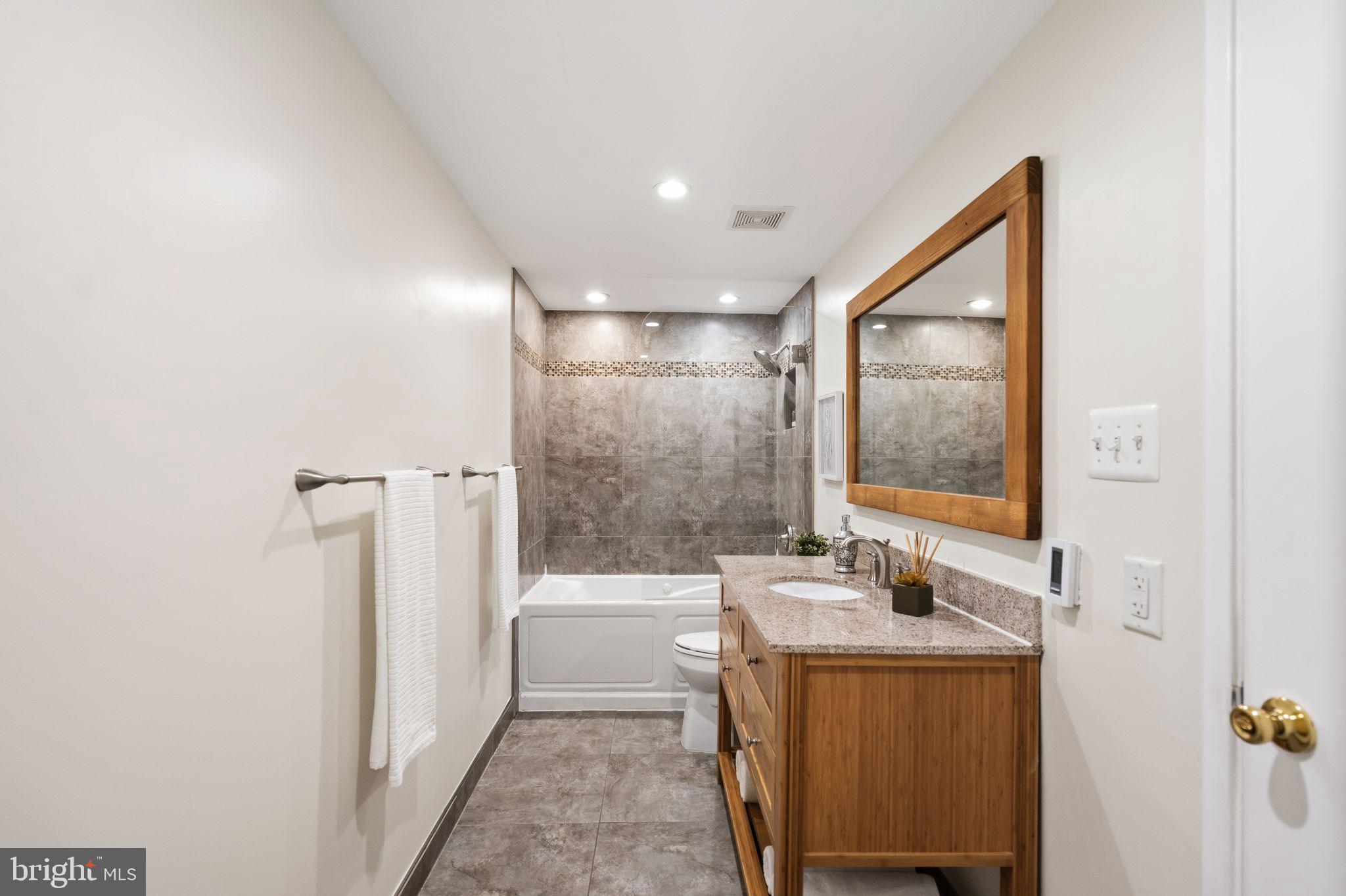 3225 Grace Street Northwest, Unit 226 Washington, DC 20007 - Photo 25 of 45 a bathroom with a sink and a mirror