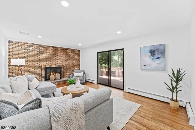 a living room with furniture large window and a fireplace