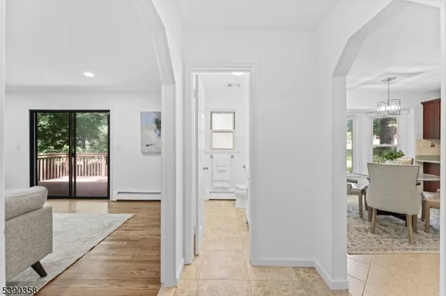 a bathroom with a tub shower and mirror