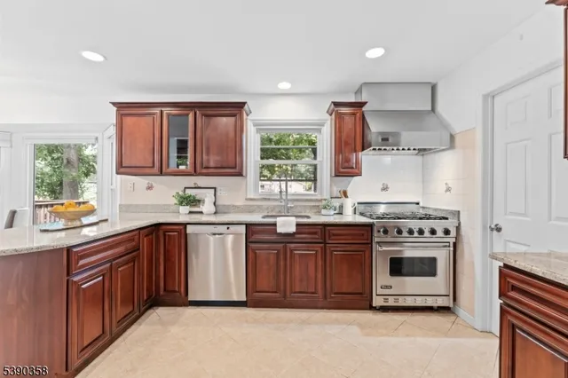a kitchen with stainless steel appliances a stove a sink and a microwave