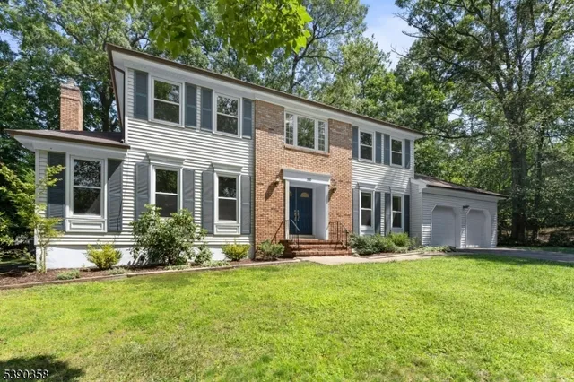 a front view of house with yard and green space
