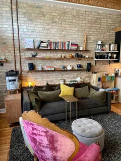 a living room with furniture and a floor to ceiling window
