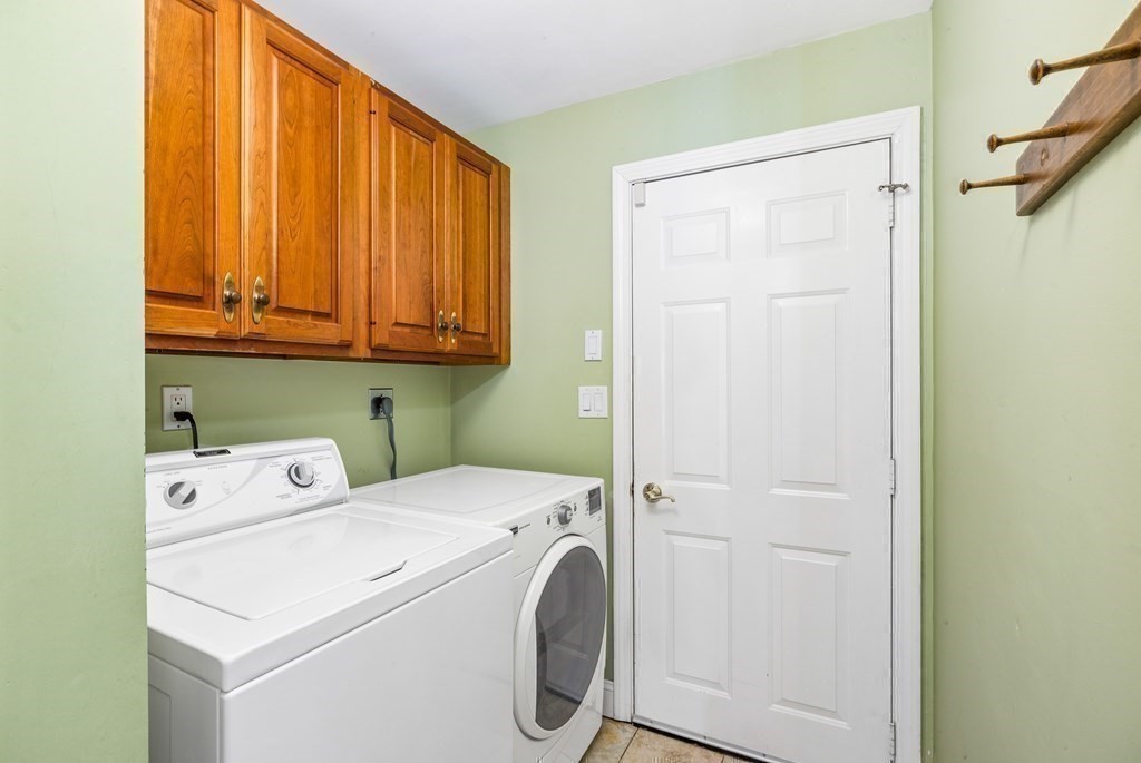 70 Thistle Patch Way, Unit 70 Hingham, MA 02043 - Photo 20 of 41 a view of washer and dryer with kitchen in the background