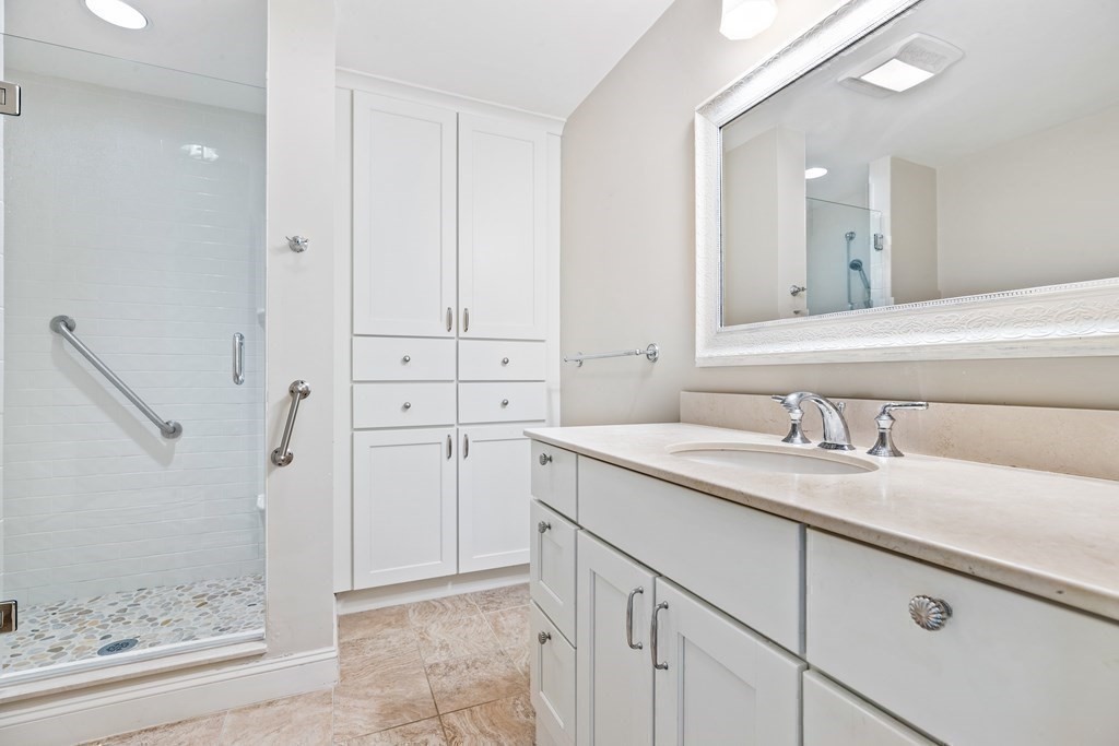 70 Thistle Patch Way, Unit 70 Hingham, MA 02043 - Photo 25 of 41 a bathroom with a granite countertop sink and a mirror