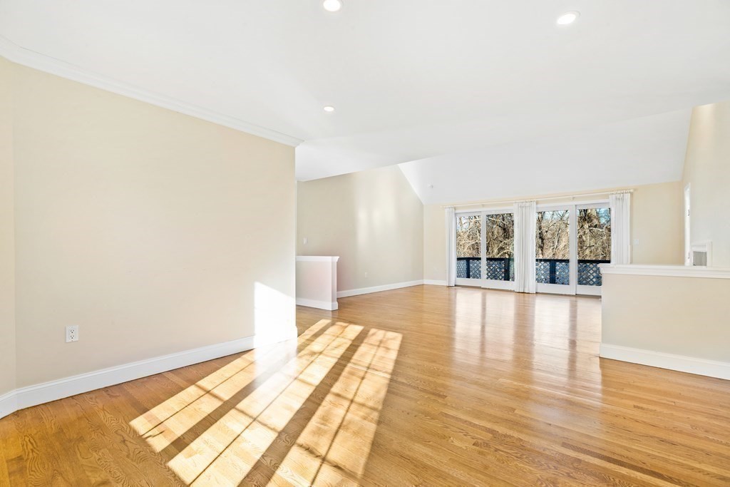 70 Thistle Patch Way, Unit 70 Hingham, MA 02043 - Photo 36 of 41 a view of an empty room with wooden floor and a window
