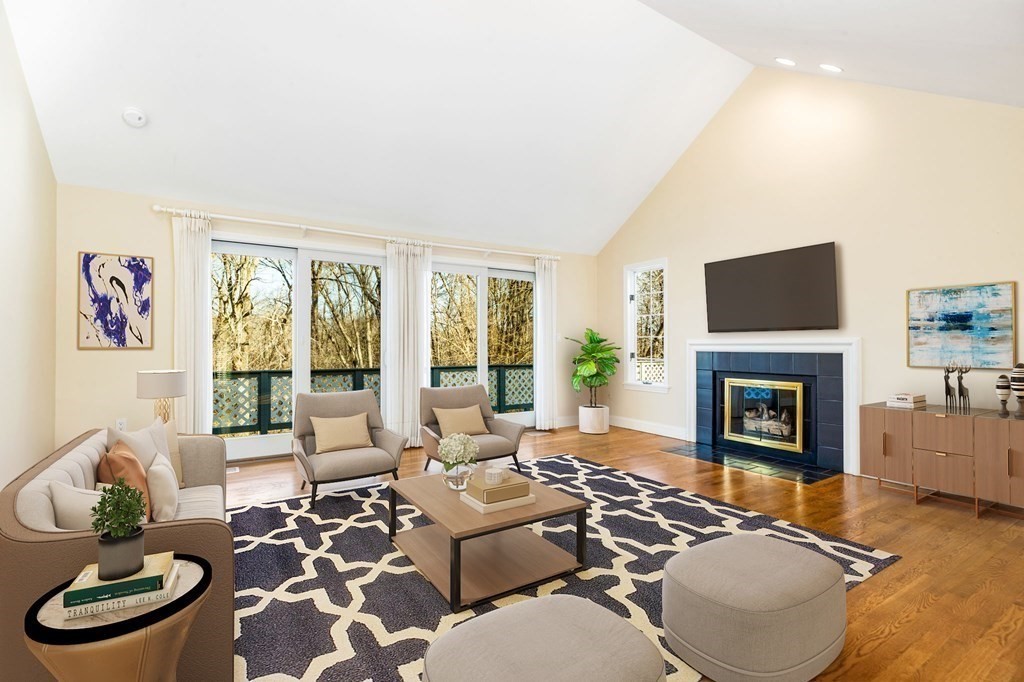 70 Thistle Patch Way, Unit 70 Hingham, MA 02043 - Photo 7 of 41 a living room with furniture a fireplace and a flat screen tv