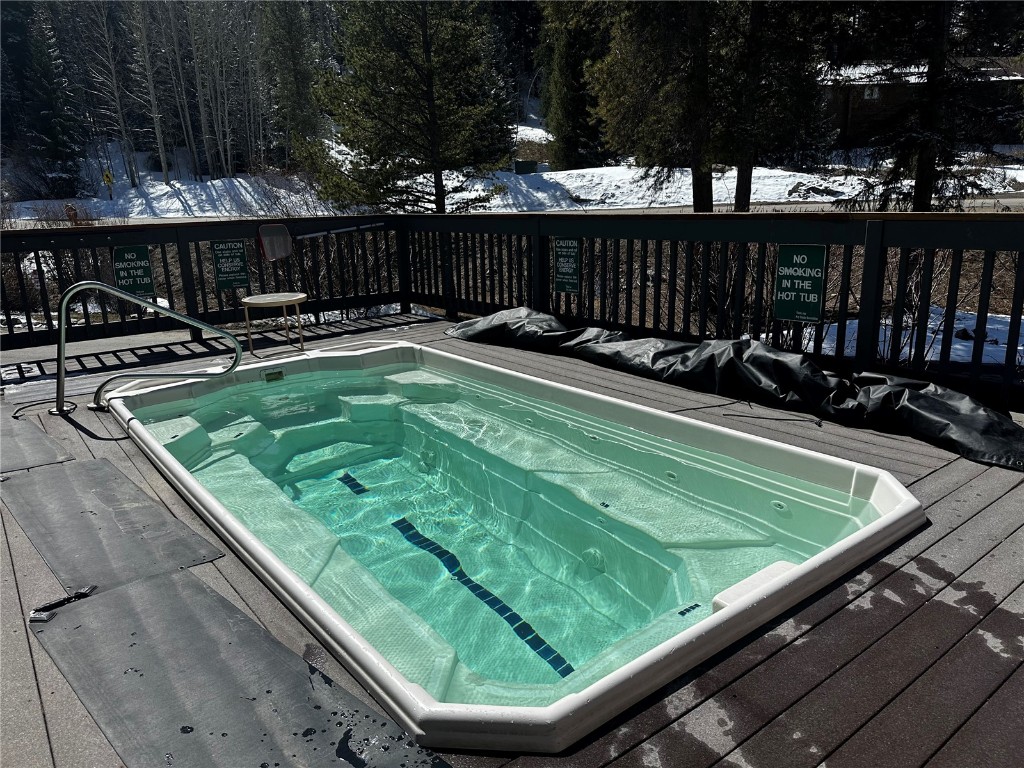1473 East Keystone Road, Unit 2931 Keystone, CO 80435 - Photo 20 of 21 Snow covered pool featuring a wooden deck and a hot tub