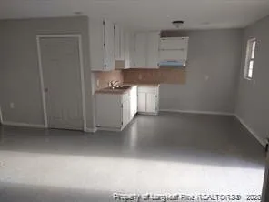 a kitchen with granite countertop a sink and a stove