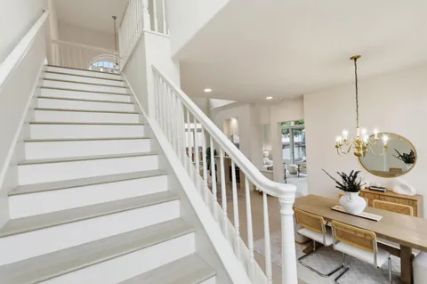 a living room with furniture and a mirror