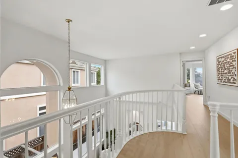 a spacious bedroom with a bed and large windows