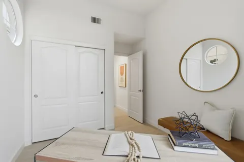 a bedroom with a bed and a painting on the wall