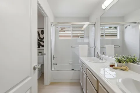 a bathroom with a sink double vanity and a mirror