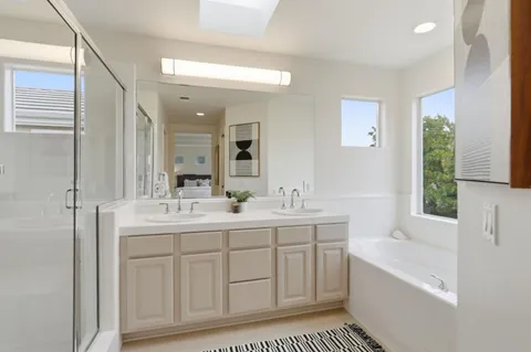 a view of a patio with table and chairs with wooden floor and fence