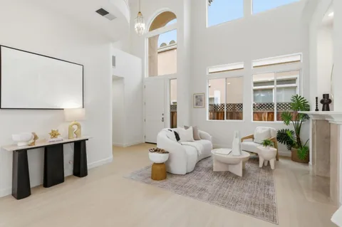 a spacious bedroom with a bed and a chandelier