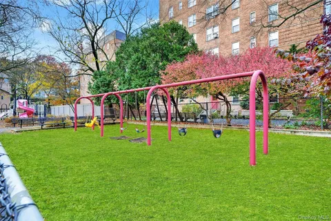 a view of yard with swimming pool and green space