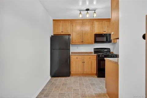 a kitchen with a refrigerator and a stove