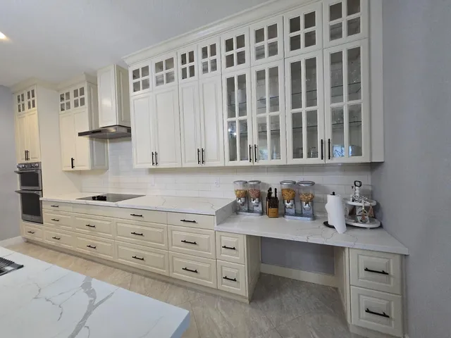 a kitchen with stainless steel appliances kitchen island granite countertop a stove a sink a refrigerator and a fireplace