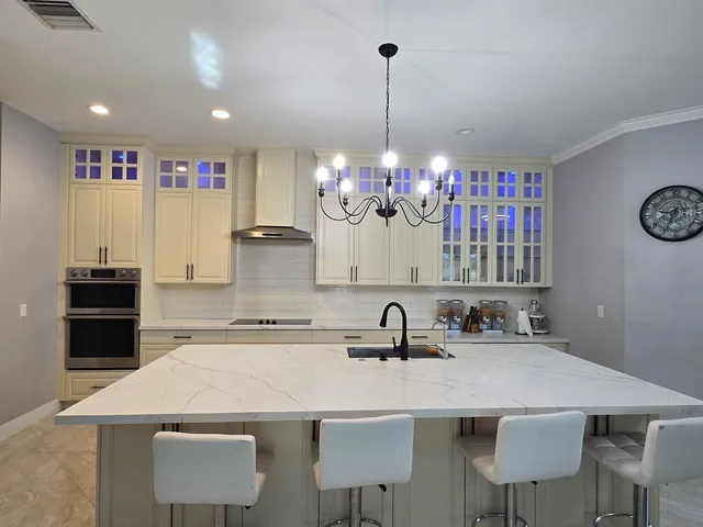 a living room with furniture a chandelier and a dining table