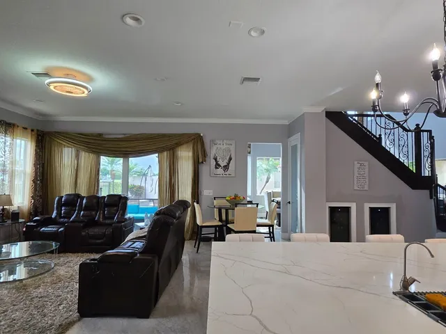 a very nice looking room with a large window and furniture