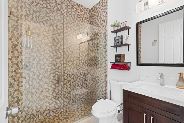 a bathroom with a toilet and a shower