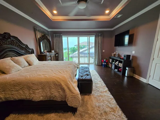 a view of a hallway with wooden floor and stairs