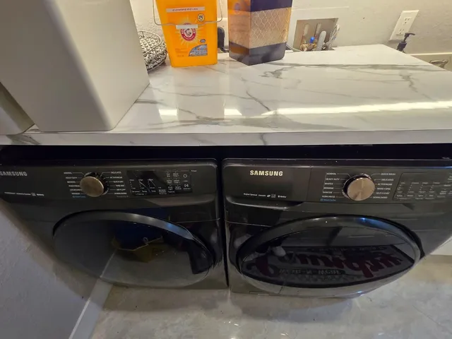 a view of green field with trees in the background