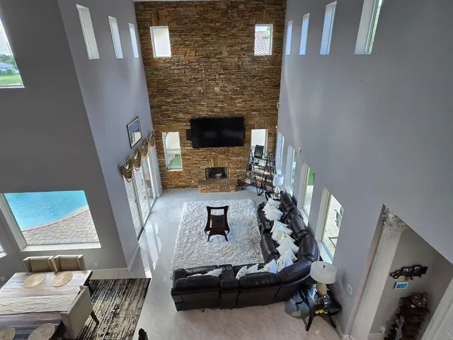 a living room with furniture wooden floor and a fireplace
