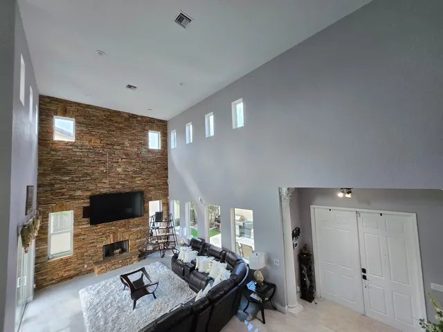 a living room with furniture and a piano
