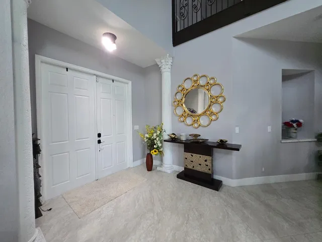 a large kitchen with kitchen island a stove a table and chairs
