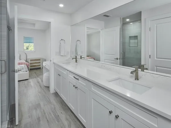 a spacious bathroom with a double vanity sink and a mirror