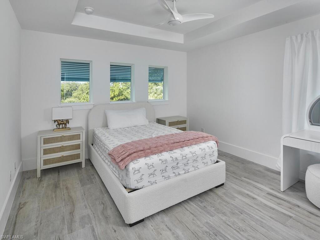 1448 10th Street North Naples, FL 34102 - Photo 12 of 18 a bedroom with a bed and a table