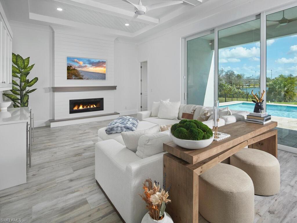 1448 10th Street North Naples, FL 34102 - Photo 2 of 18 a living room with furniture and a floor to ceiling window