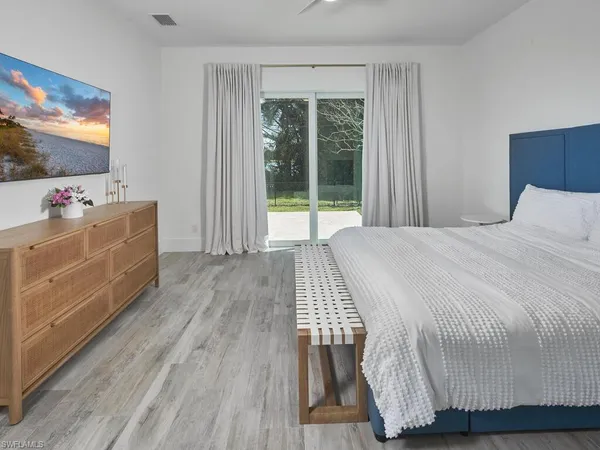a room with a bed and flat screen tv