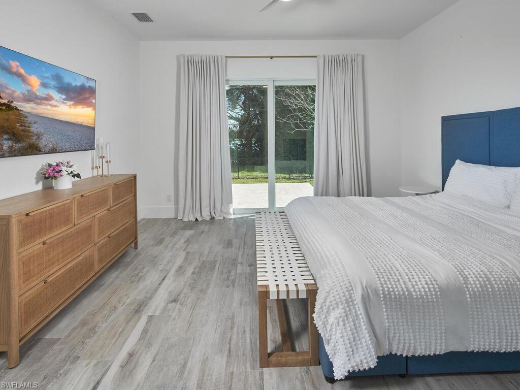 1448 10th Street North Naples, FL 34102 - Photo 6 of 18 a room with a bed and flat screen tv
