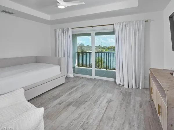 a bedroom with a bed and a large window