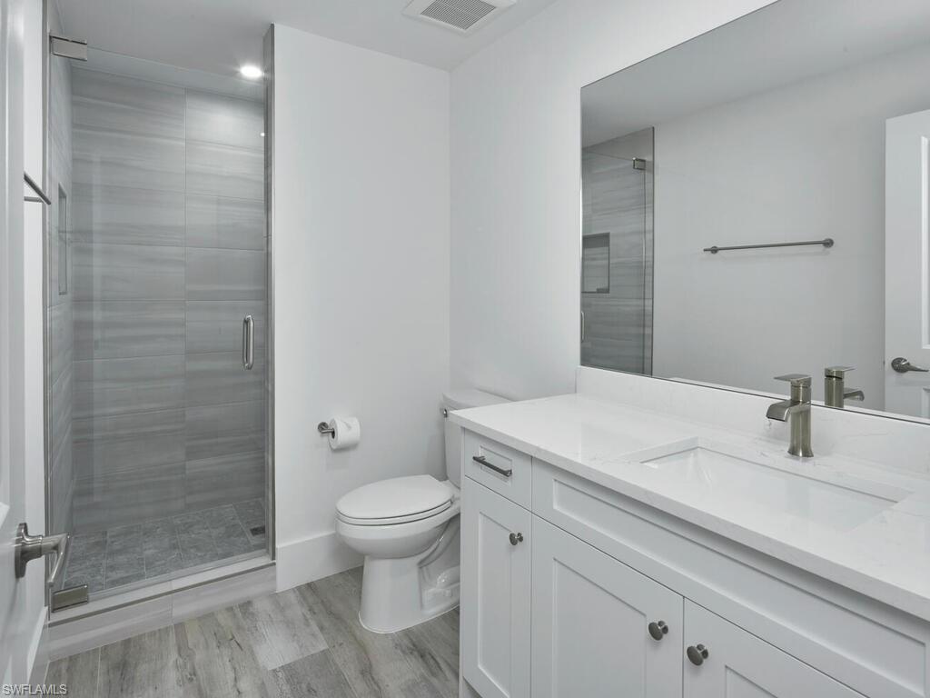 1448 10th Street North Naples, FL 34102 - Photo 9 of 18 a bathroom with a sink a toilet and shower