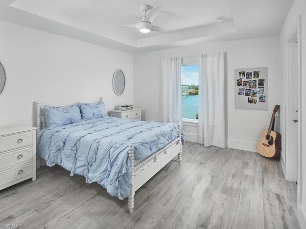 a bedroom with a bed and a chandelier