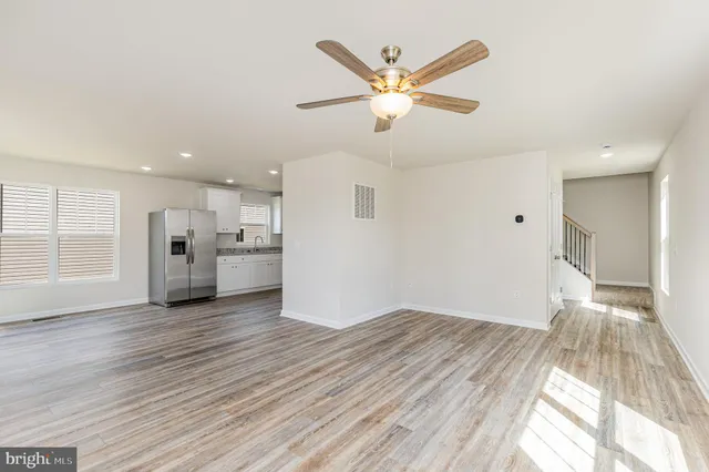 a view of a kitchen with a sink and dishwasher wooden floor