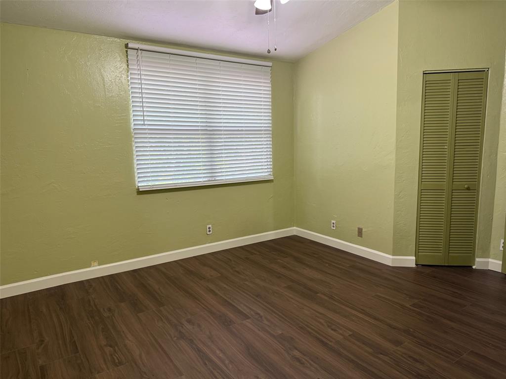 11571 Northwest 35th Street, Unit 11571 Coral Springs, FL 33065 - Photo 13 of 29 an empty room with wooden floor and windows