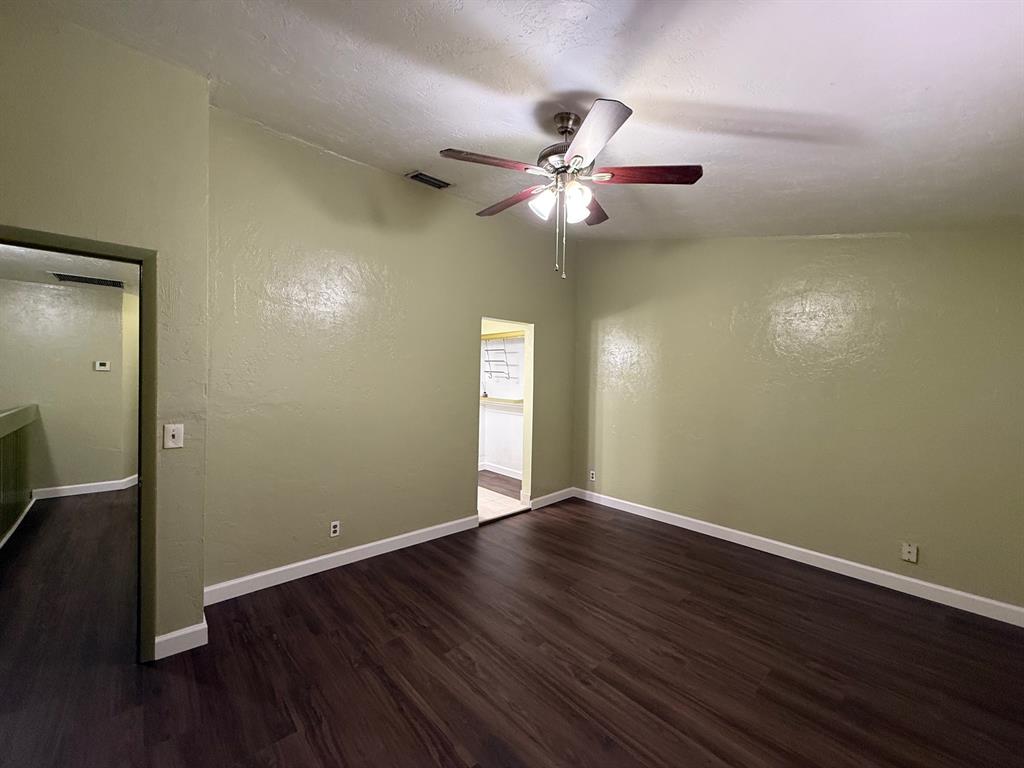 11571 Northwest 35th Street, Unit 11571 Coral Springs, FL 33065 - Photo 14 of 29 an empty room with wooden floor fan and windows