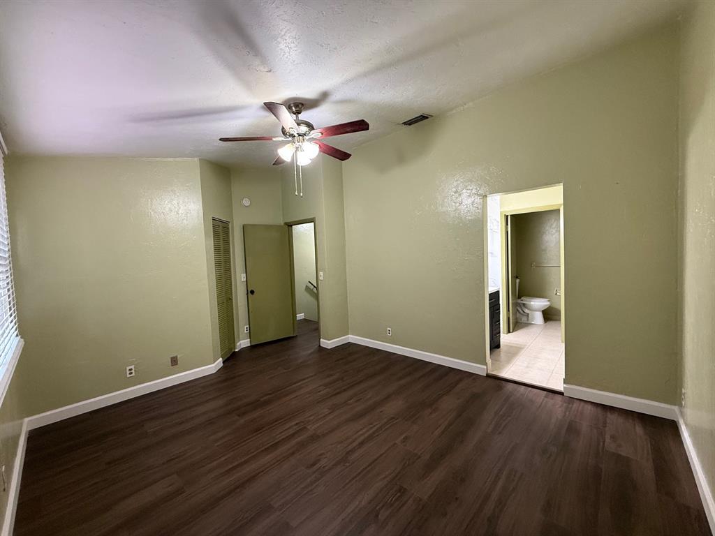 11571 Northwest 35th Street, Unit 11571 Coral Springs, FL 33065 - Photo 15 of 29 an empty room with wooden floor and a ceiling fan