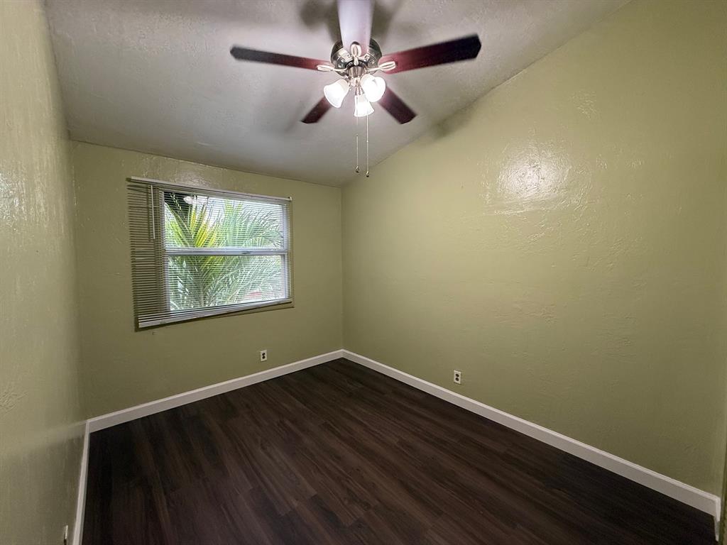11571 Northwest 35th Street, Unit 11571 Coral Springs, FL 33065 - Photo 18 of 29 an empty room with a window and ceiling fan
