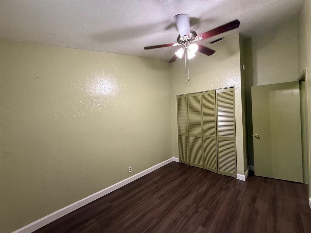 11571 Northwest 35th Street, Unit 11571 Coral Springs, FL 33065 - Photo 20 of 29 an empty room with wooden floor and fan