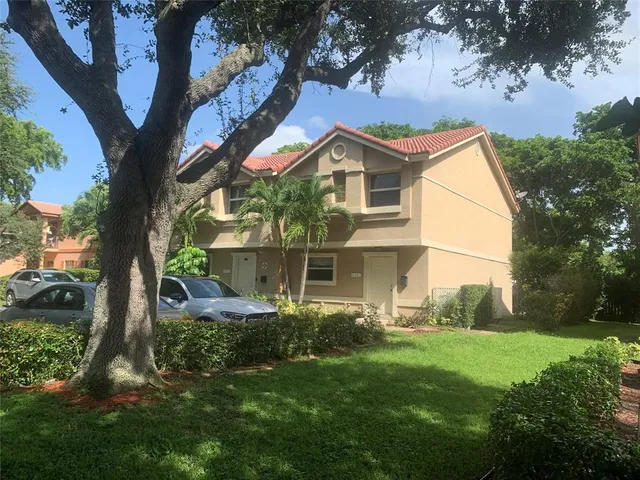 a front view of house with yard and green space