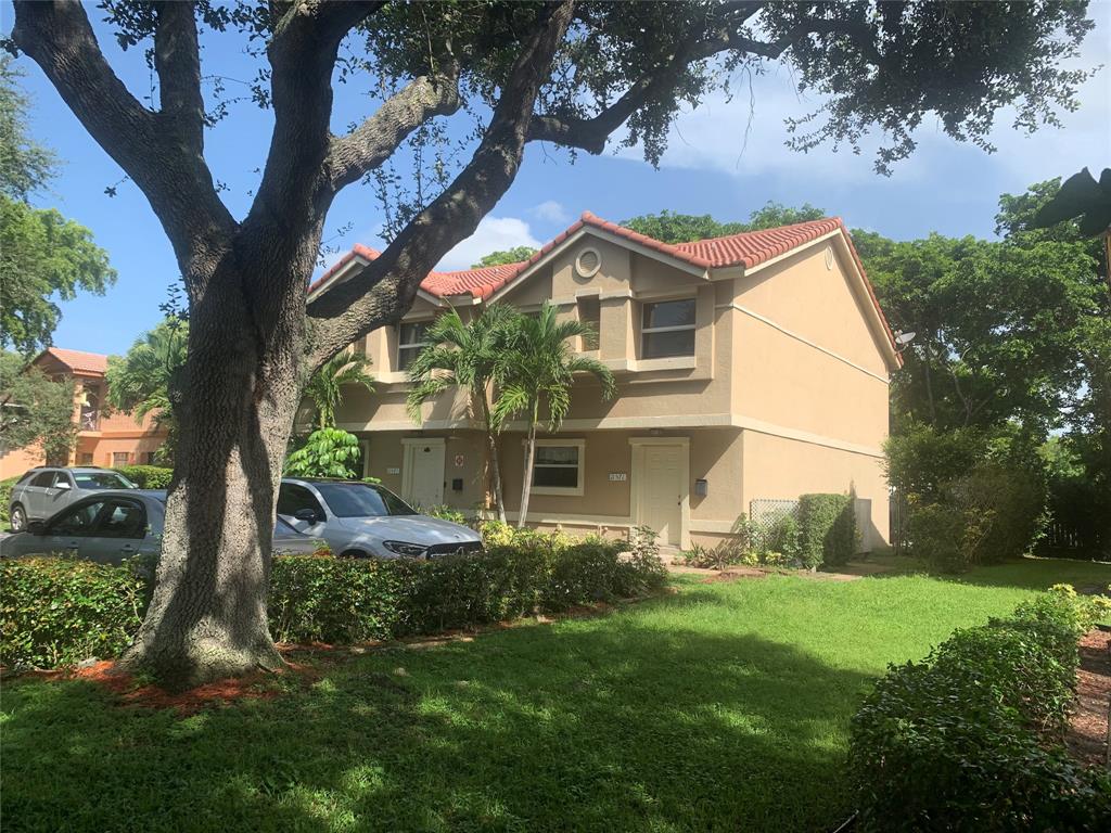 11571 Northwest 35th Street, Unit 11571 Coral Springs, FL 33065 - Photo 2 of 29 a front view of house with yard and green space