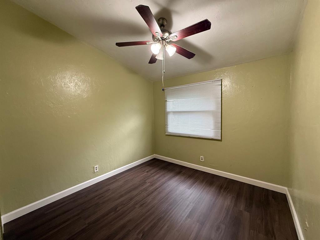 11571 Northwest 35th Street, Unit 11571 Coral Springs, FL 33065 - Photo 21 of 29 an empty room with wooden floor and ceiling fan